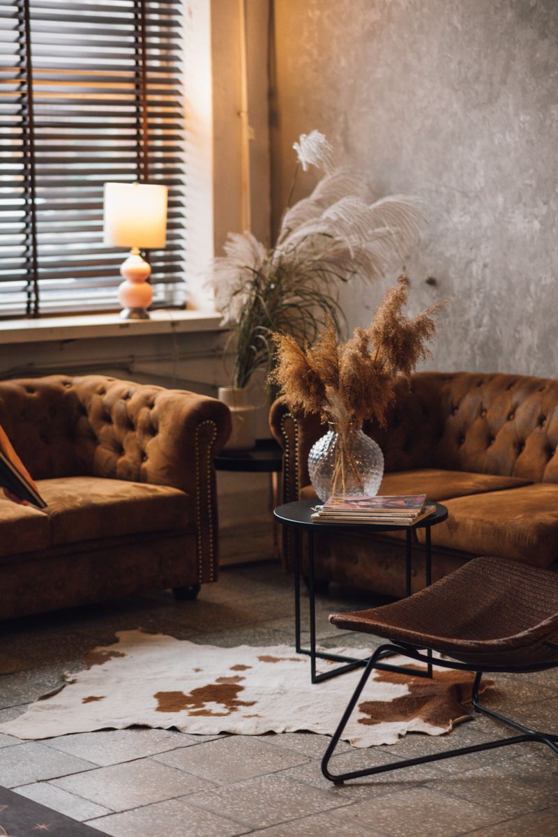Warm and stylish living room interior with sofas and decorative elements.