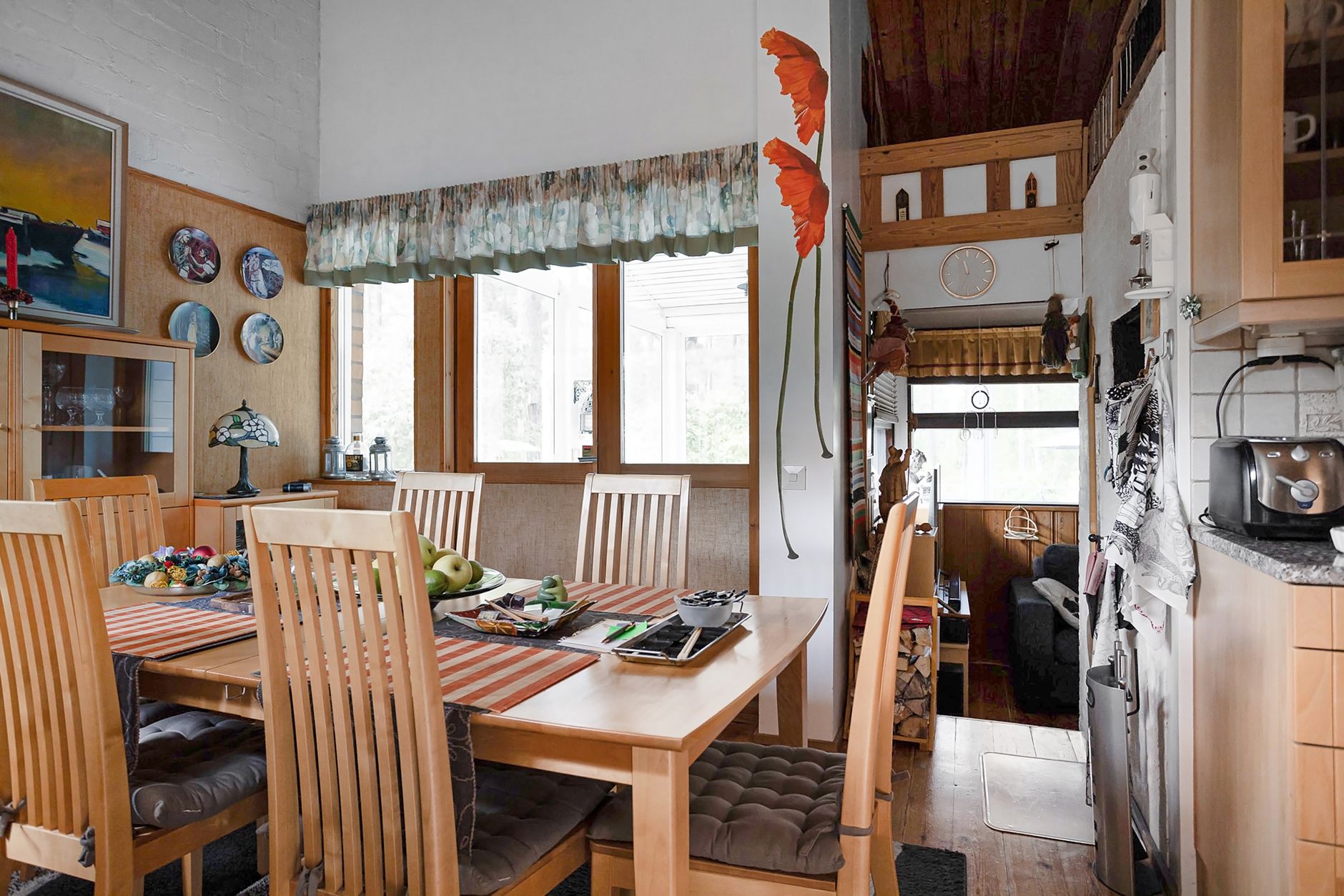 Warm and inviting dining room featuring wooden furniture and artistic decor elements.